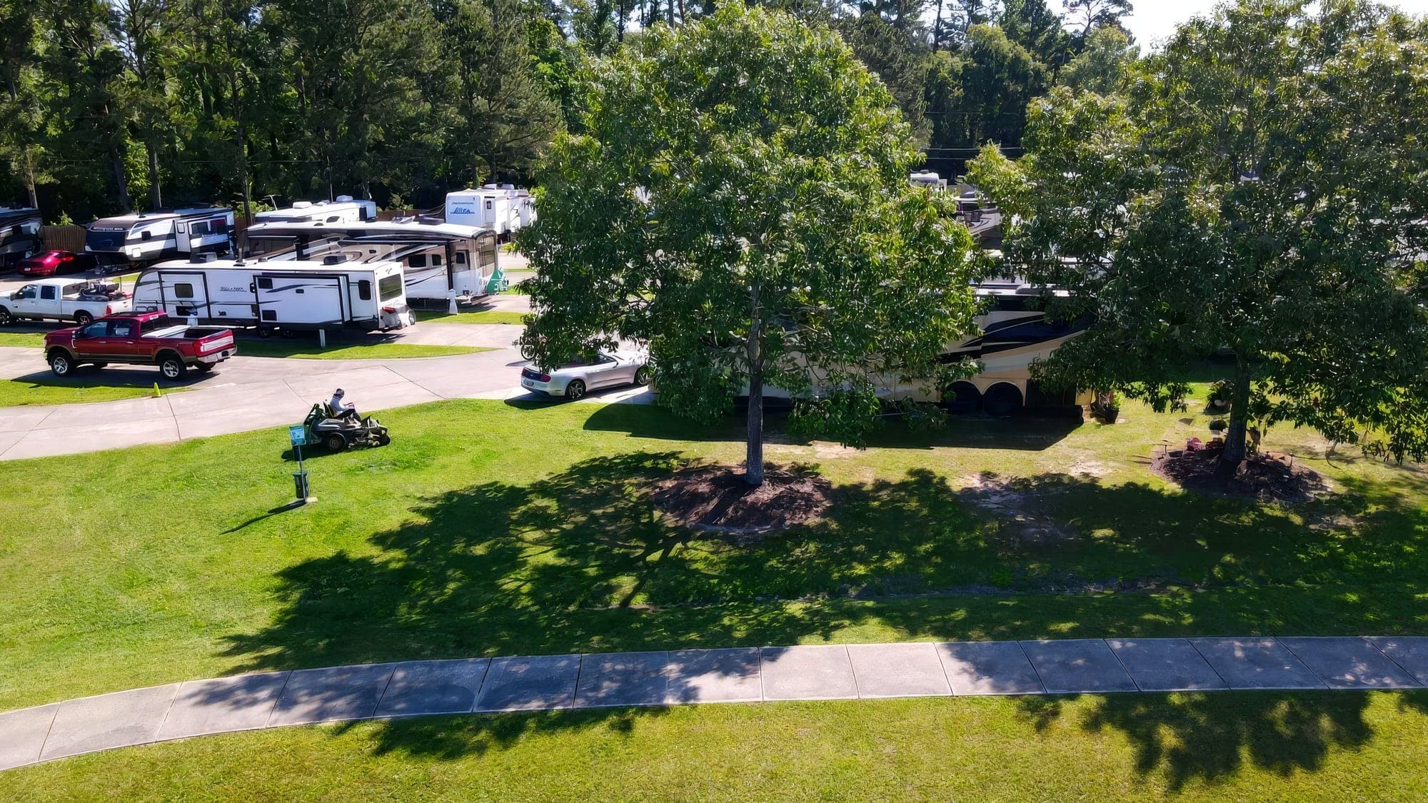 Aerial view of a zero-turn mower cutting the lawn at an RV park
