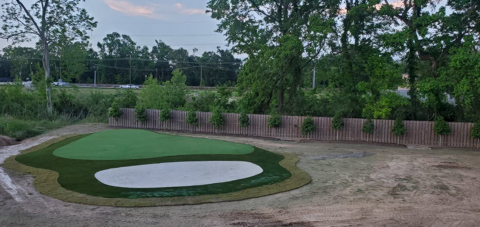 Finished artificial turf beside the pool, viewed from the patio