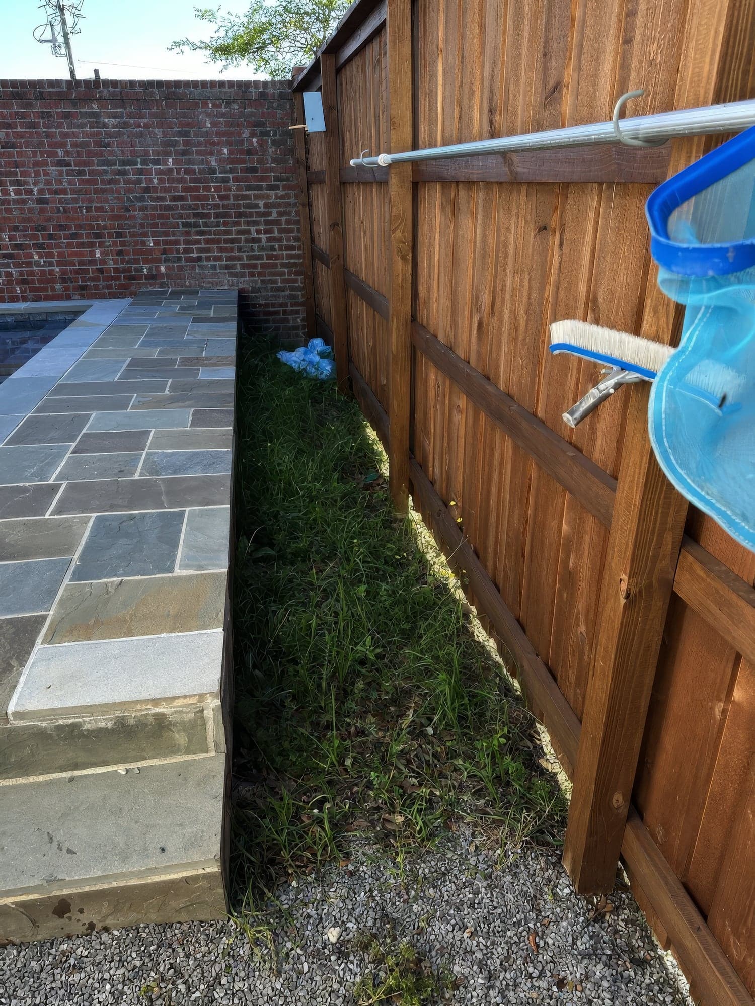 A bare backyard beside a new pool before landscaping