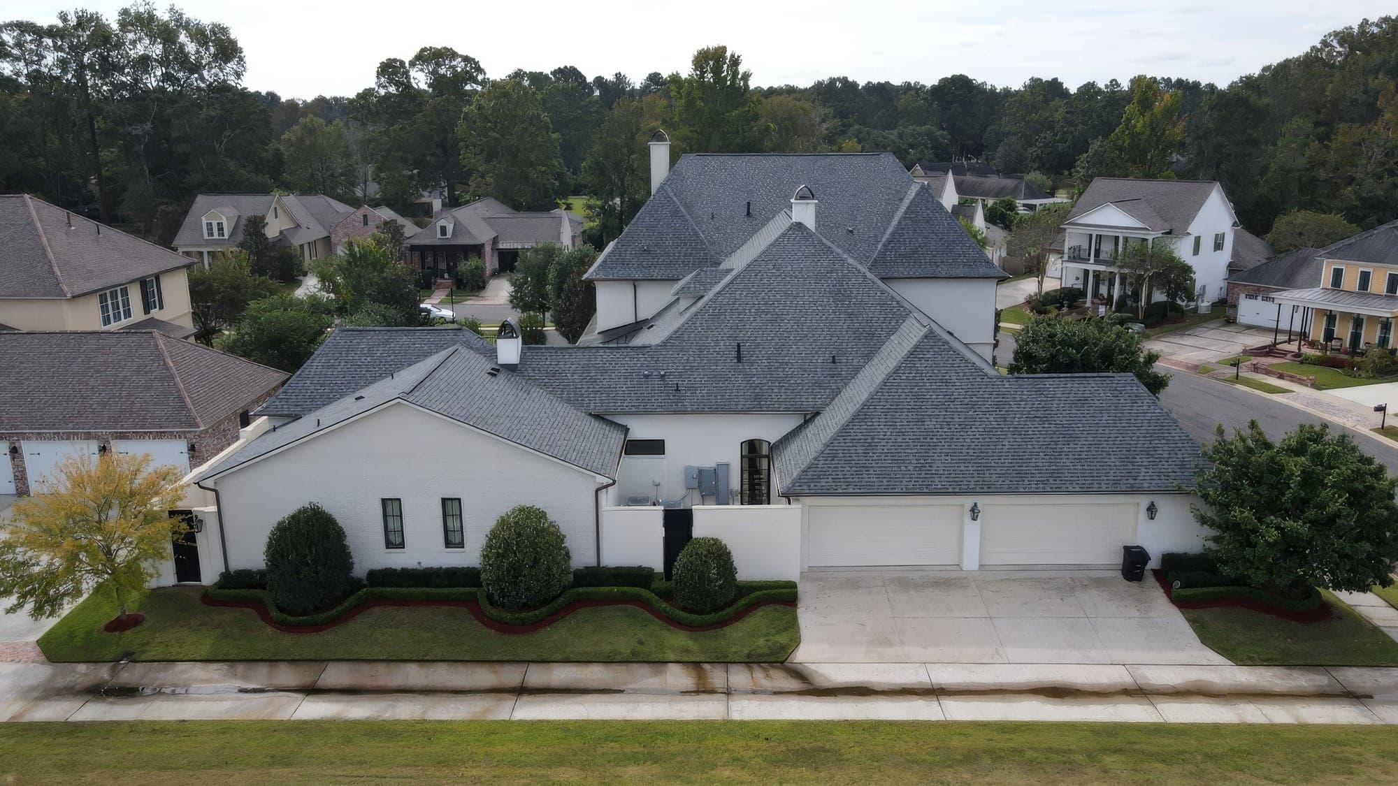 Aerial view of a rear courtyard with a small pool and hedged beds