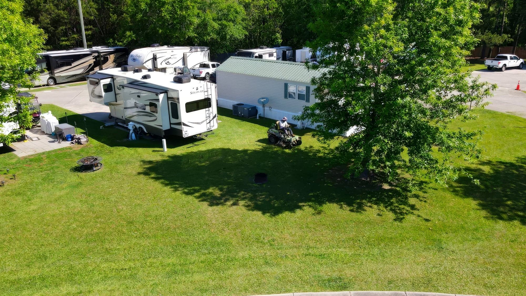 Aerial view of an RV park lawn with a zero-turn mower